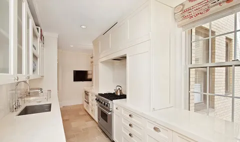 a view of a kitchen with a sink and a window