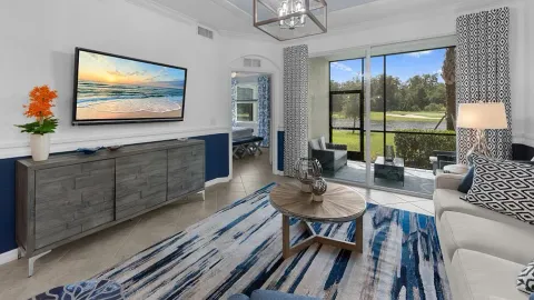 a living room with furniture a large window and a flat screen tv