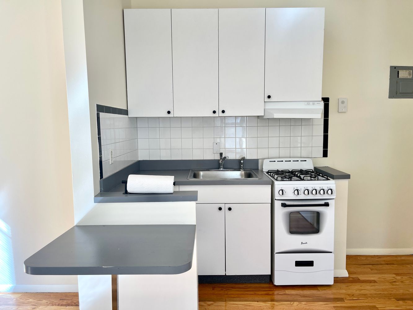 1672 Park Avenue Manhattan, NY 10035 - Photo 15 of 35 a kitchen with a stove and white cabinets