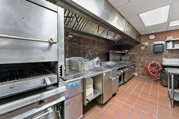 a kitchen with a stove and a refrigerator