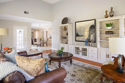 a living room with furniture and a wooden floor
