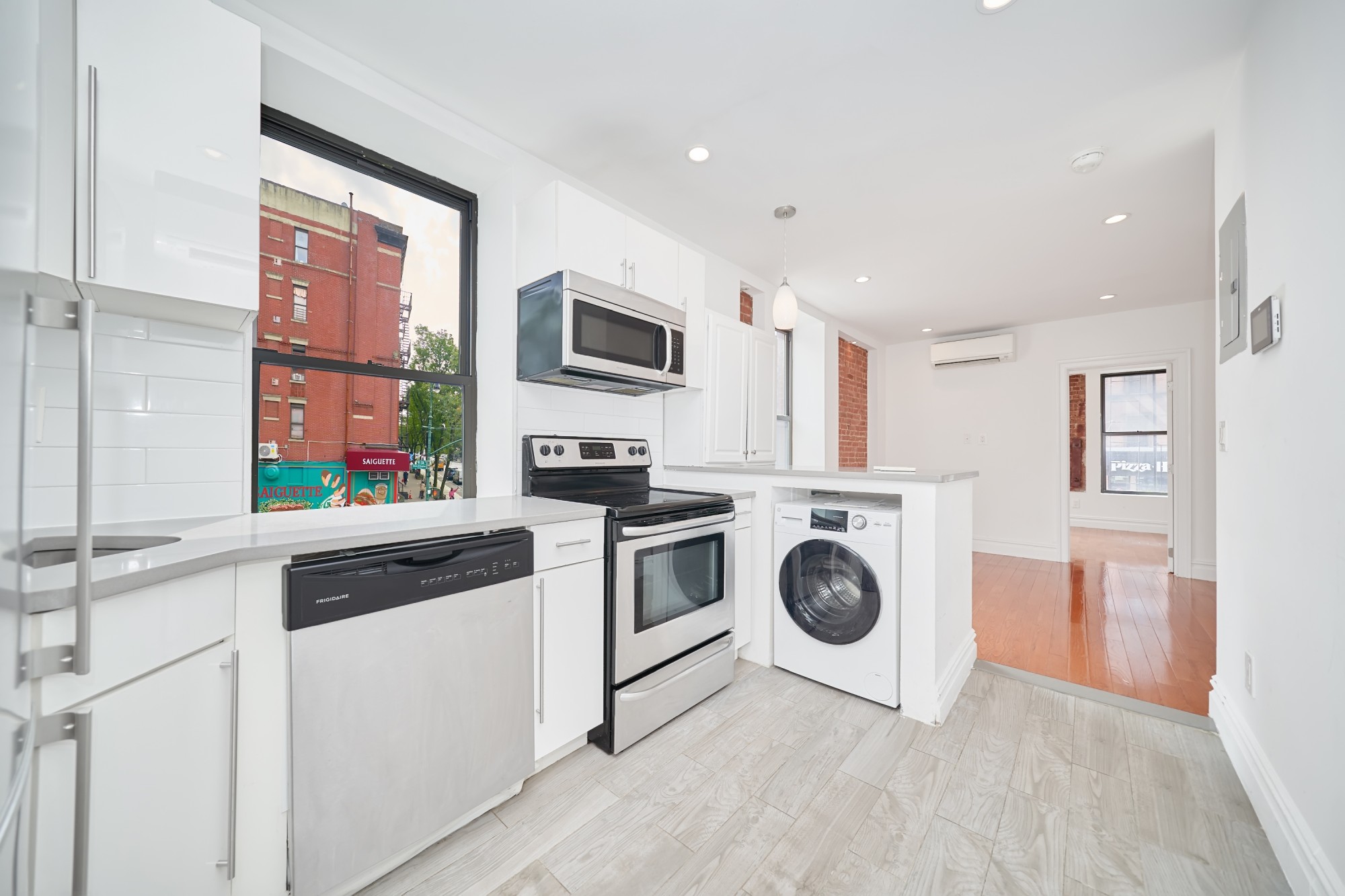 941 Columbus Avenue, Unit 1A Manhattan, NY 10025 - Photo 7 of 14 a view of kitchen and washer and dryer
