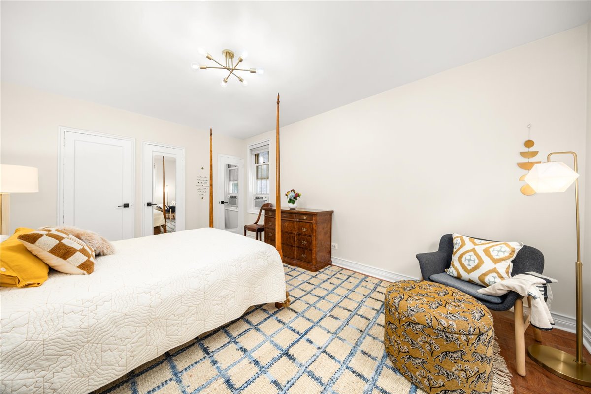 360 Clinton Avenue, Unit 1D Brooklyn, NY 11238 - Photo 9 of 17 a bedroom with a bed and a chandelier