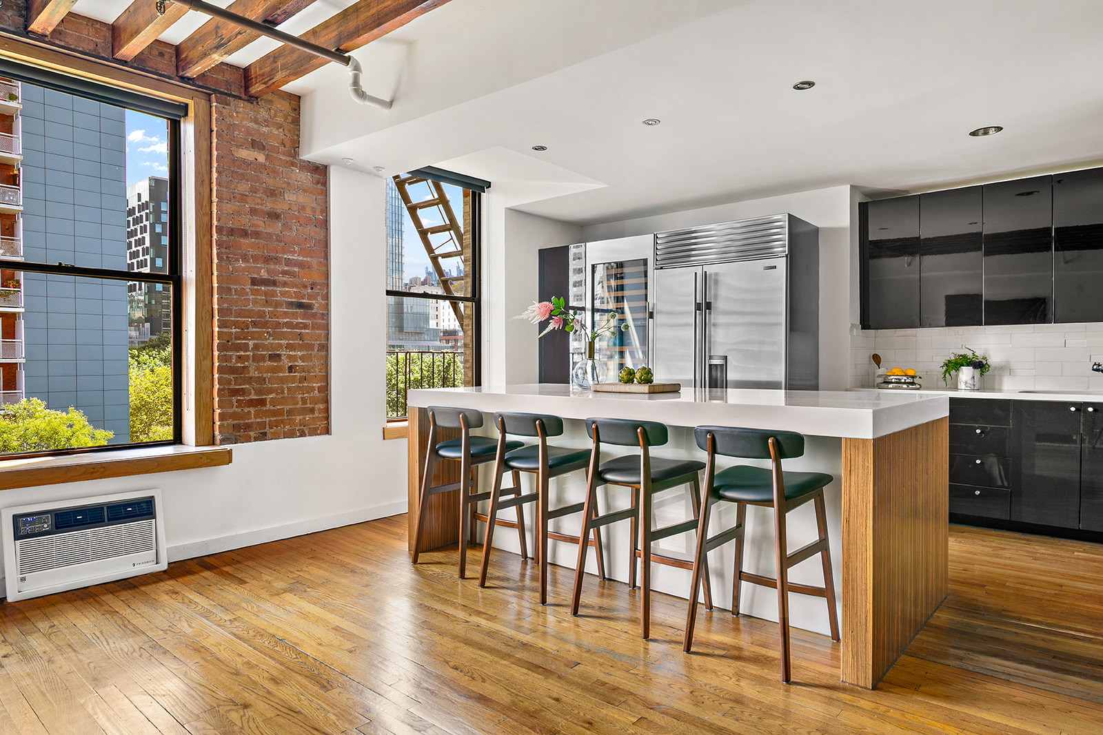 520 LaGuardia Place, Unit 6N Manhattan, NY 10012 - Photo 4 of 11 a dining room with stainless steel appliances granite countertop a stove and a wooden floors