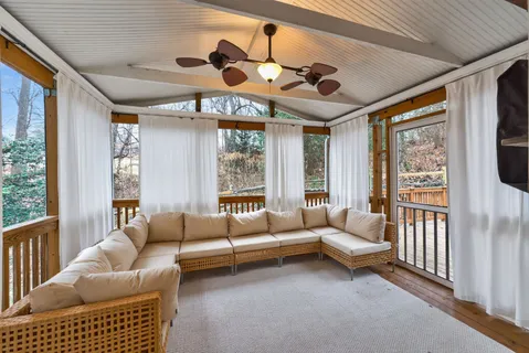 a view of a chairs and table in the back yard of the house