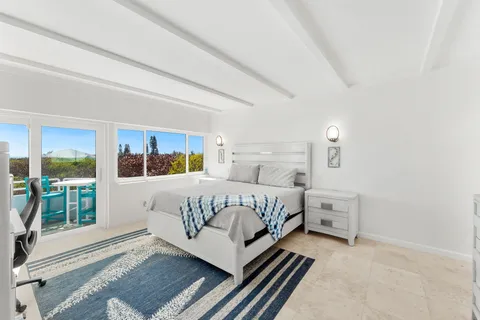 a bedroom with a bed lamp and window