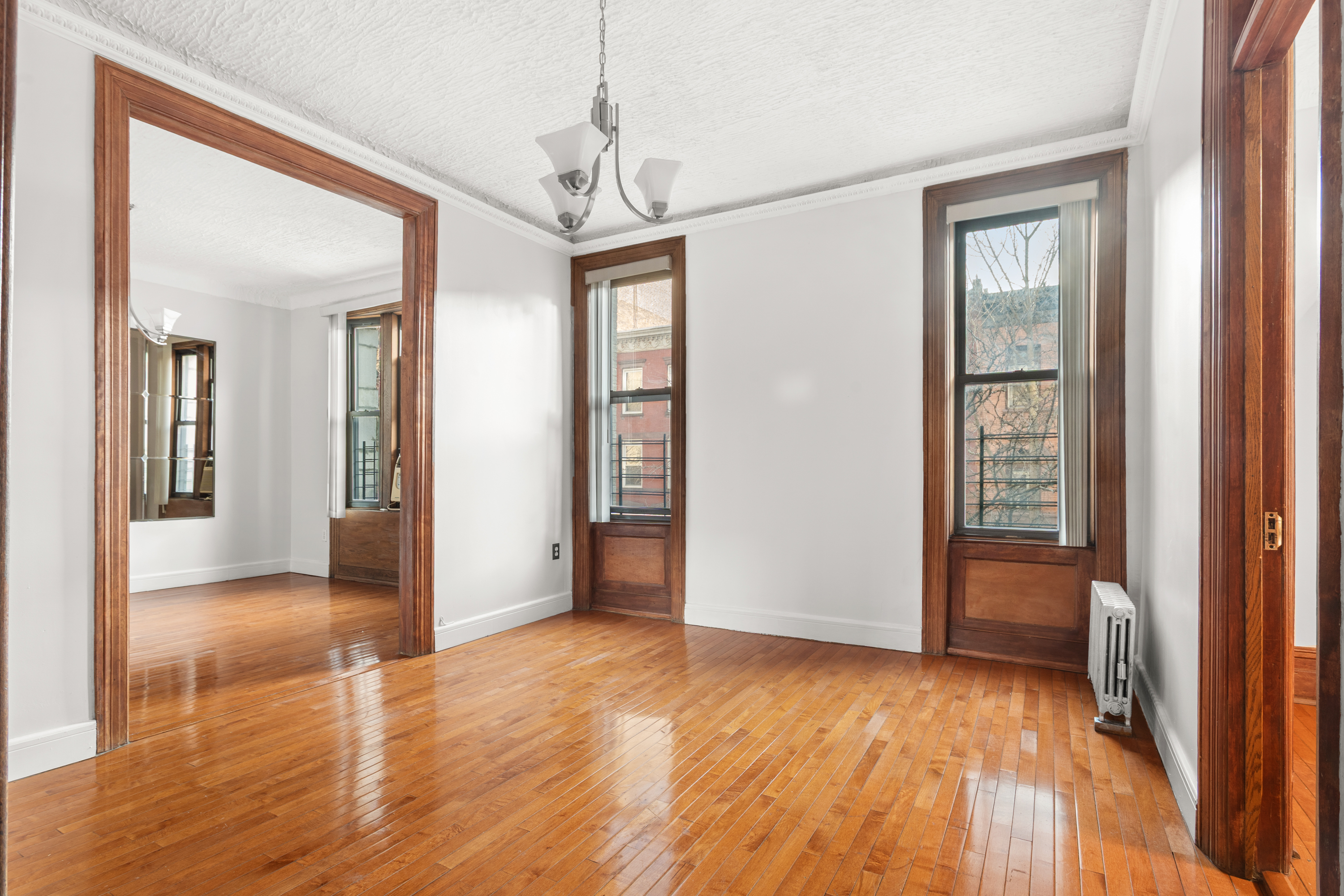 527 West 143rd Street, Unit 31 Manhattan, NY 10031 - Photo 4 of 29 a view of livingroom with hardwood floor and hallway