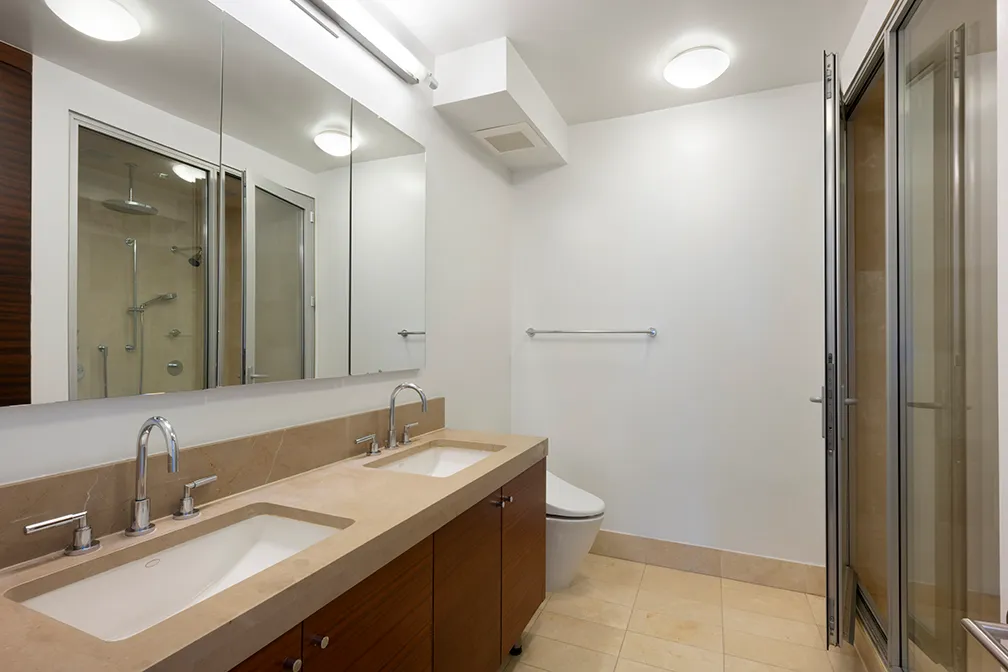 a bathroom with a double vanity sink mirror and toilet