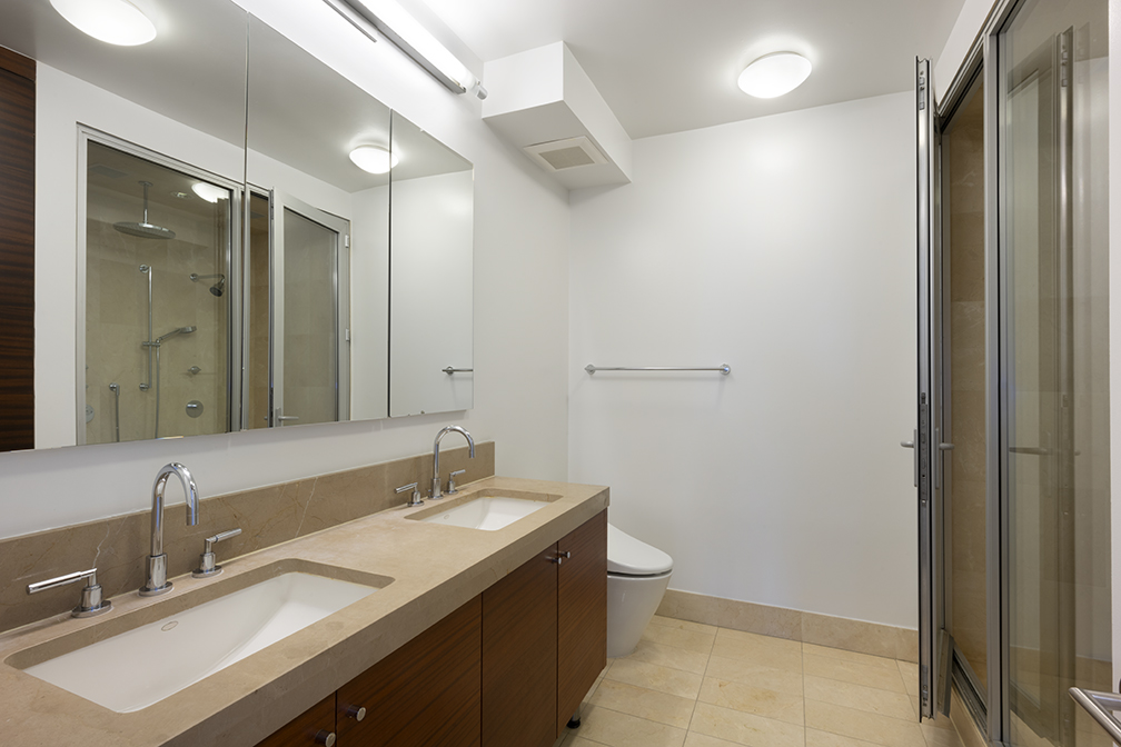 30 West Street, Unit 21AB Manhattan, NY 10004 - Photo 9 of 17 a bathroom with a double vanity sink mirror and toilet