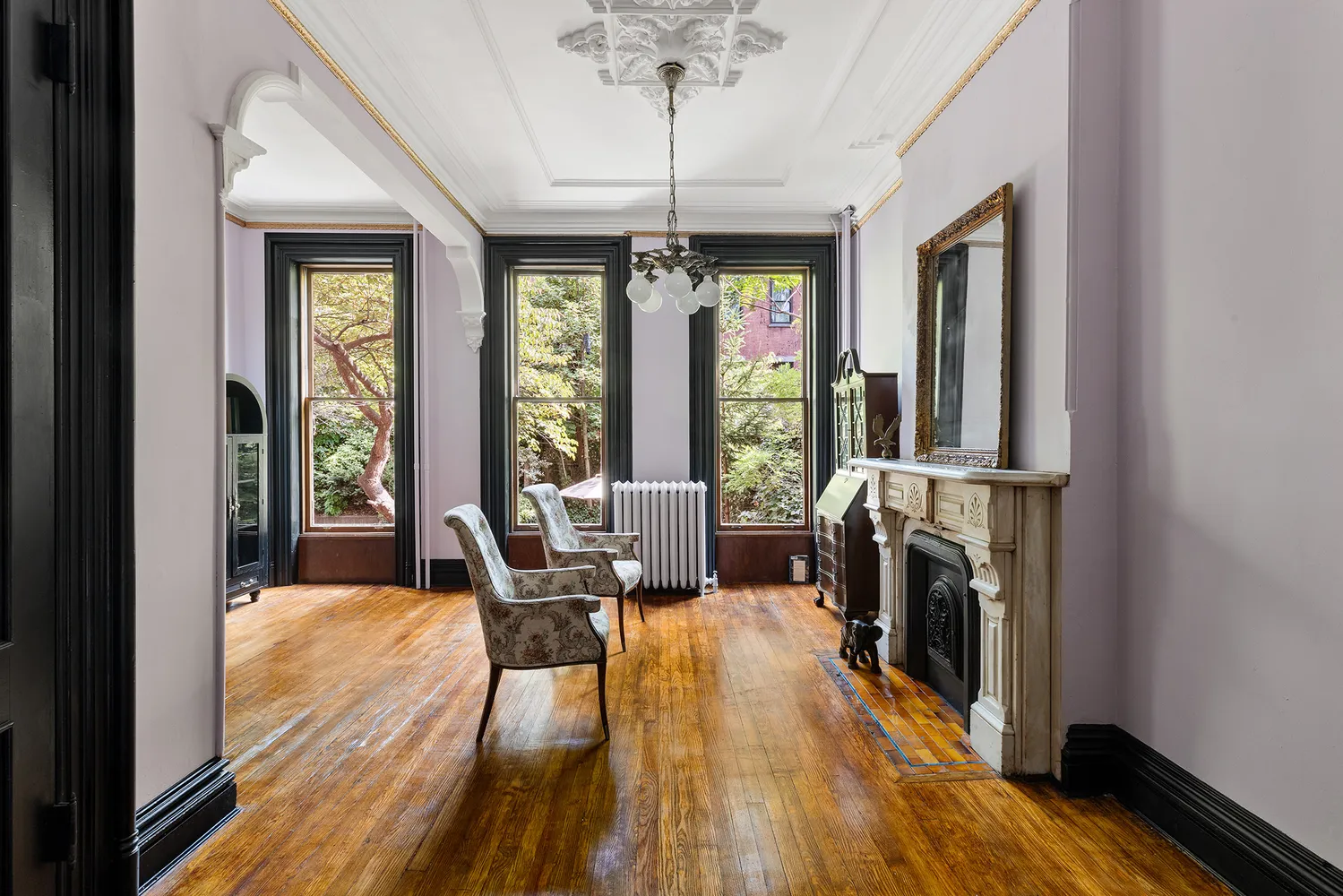 a view of a livingroom with furniture window and wooden floor