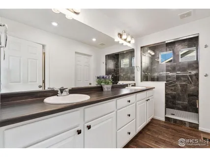 a bathroom with a sink double vanity and a mirror