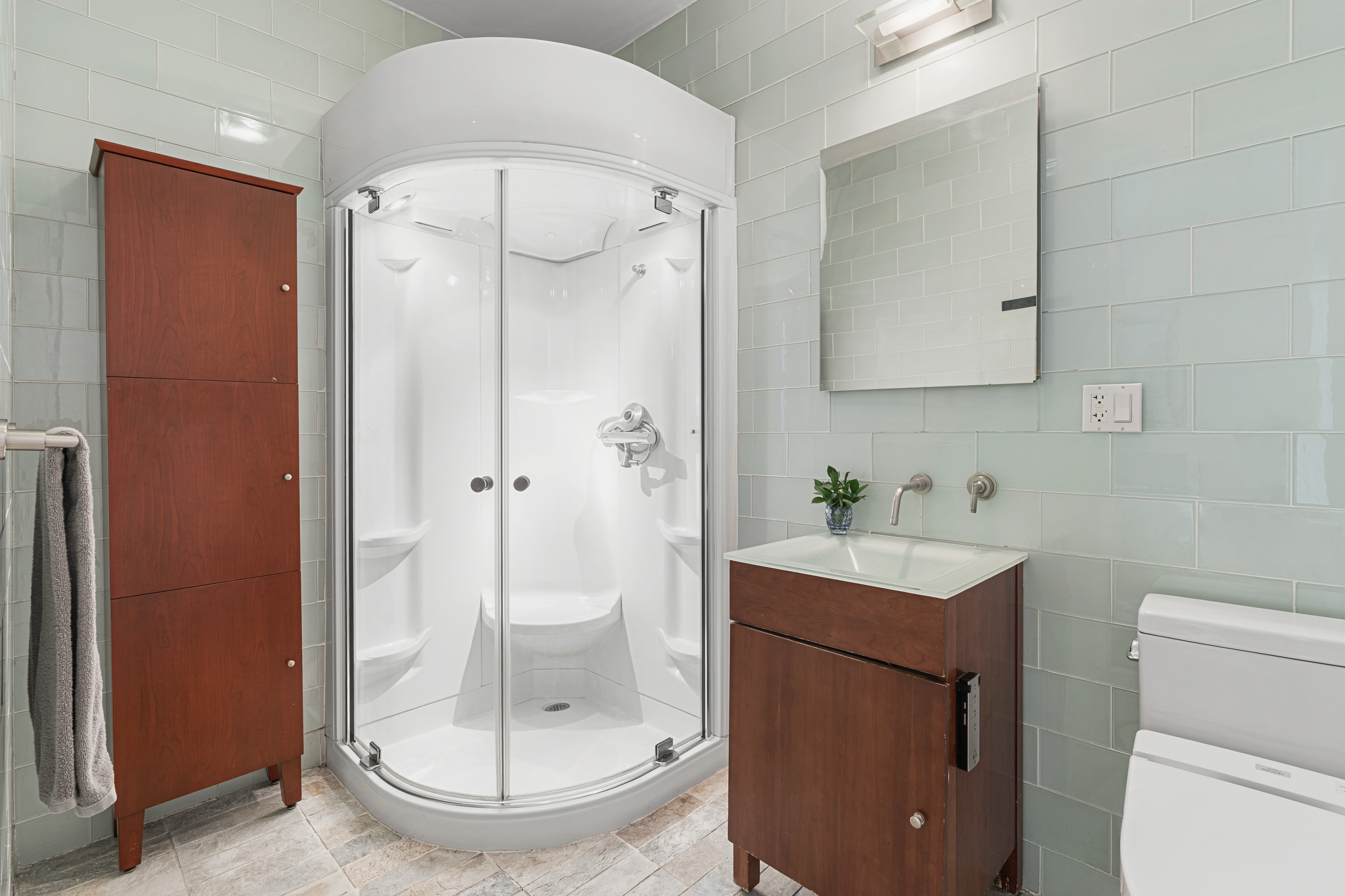 552 West 43rd Street, Unit 3A Manhattan, NY 10036 - Photo 6 of 11 a bathroom with a sink a toilet and shower