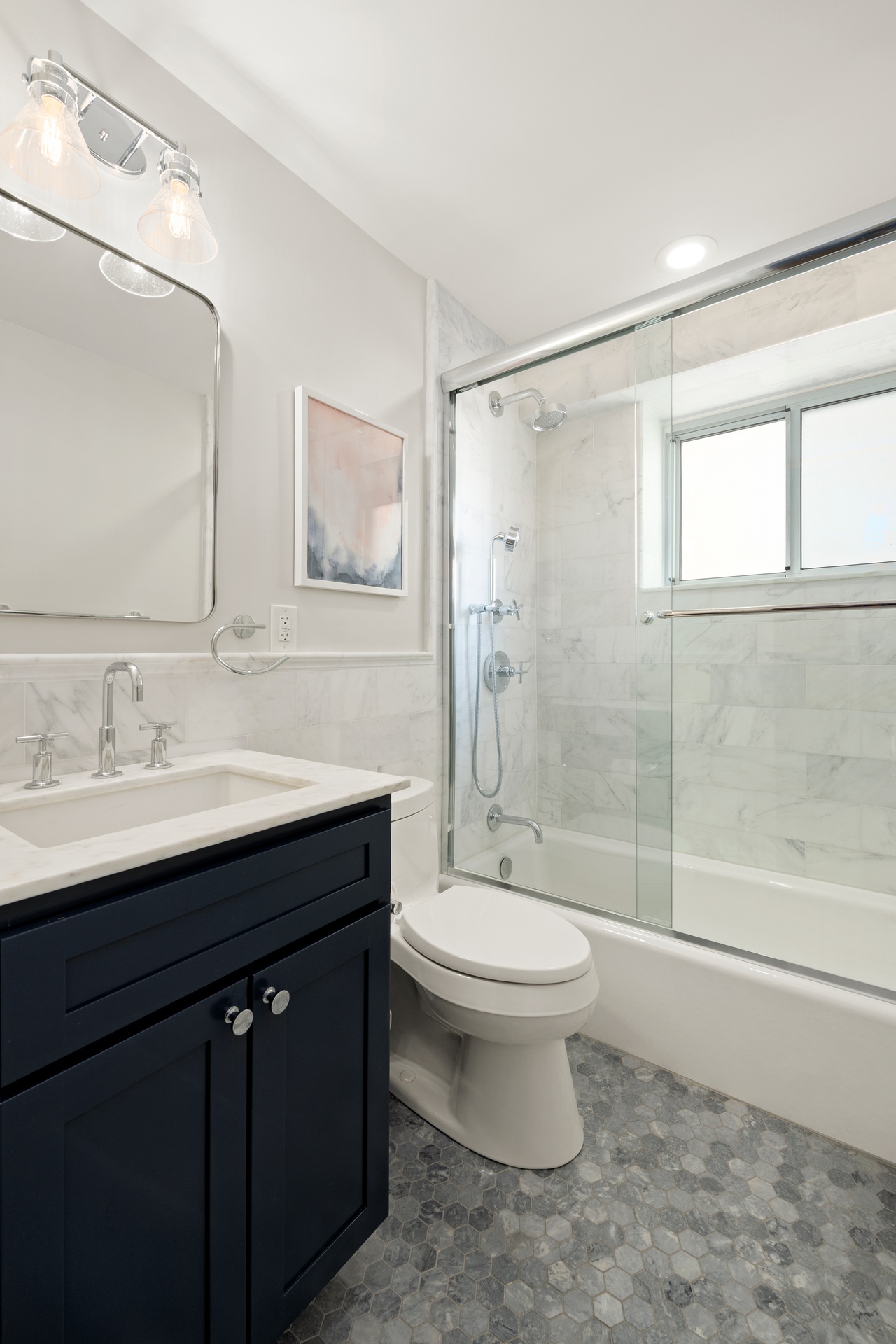 420 East 58th Street, Unit 14B Manhattan, NY 10022 - Photo 9 of 10 a bathroom with a sink toilet a mirror and shower