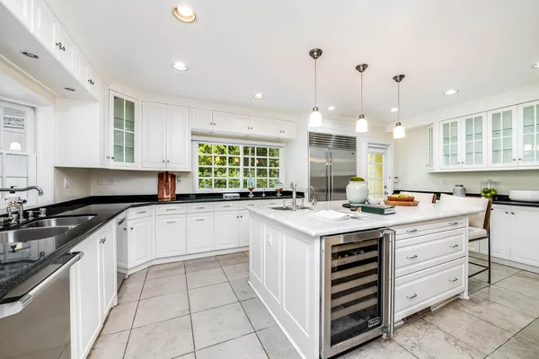 a kitchen with granite countertop a sink and cabinets