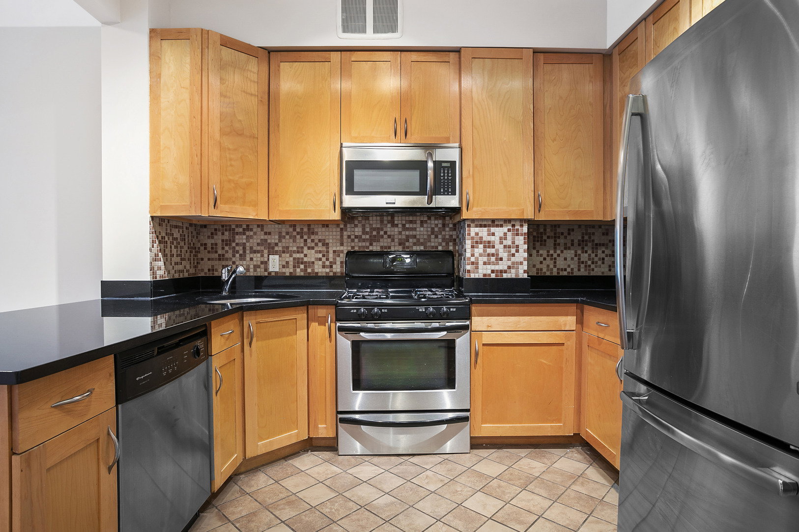 330 Bergen Street, Unit 4D Brooklyn, NY 11217 - Photo 4 of 9 a kitchen with stainless steel appliances granite countertop a refrigerator and a stove top oven