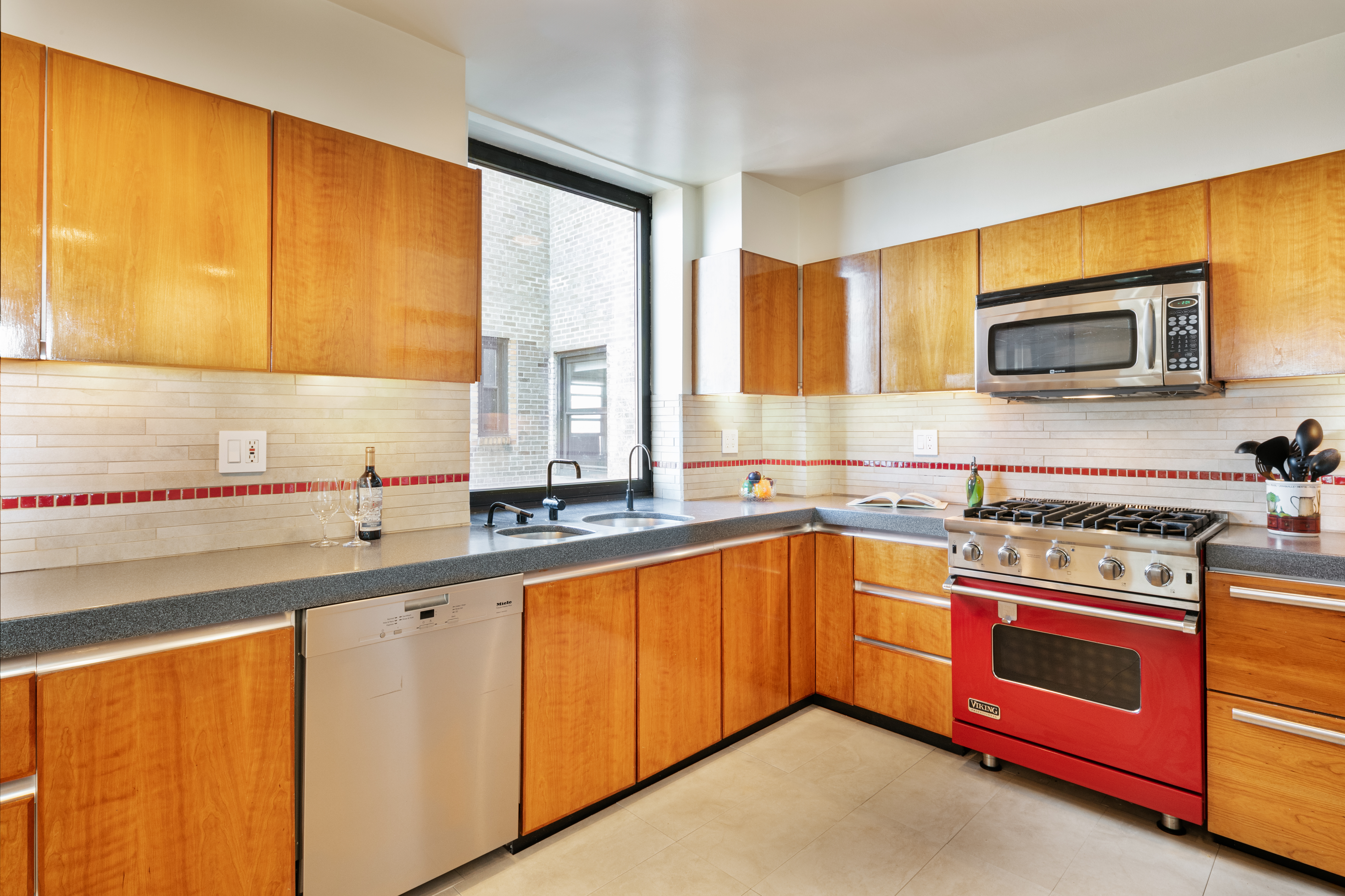 263 West End Avenue, Unit PH22B Manhattan, NY 10023 - Photo 12 of 19 a kitchen with stainless steel appliances a stove sink and microwave