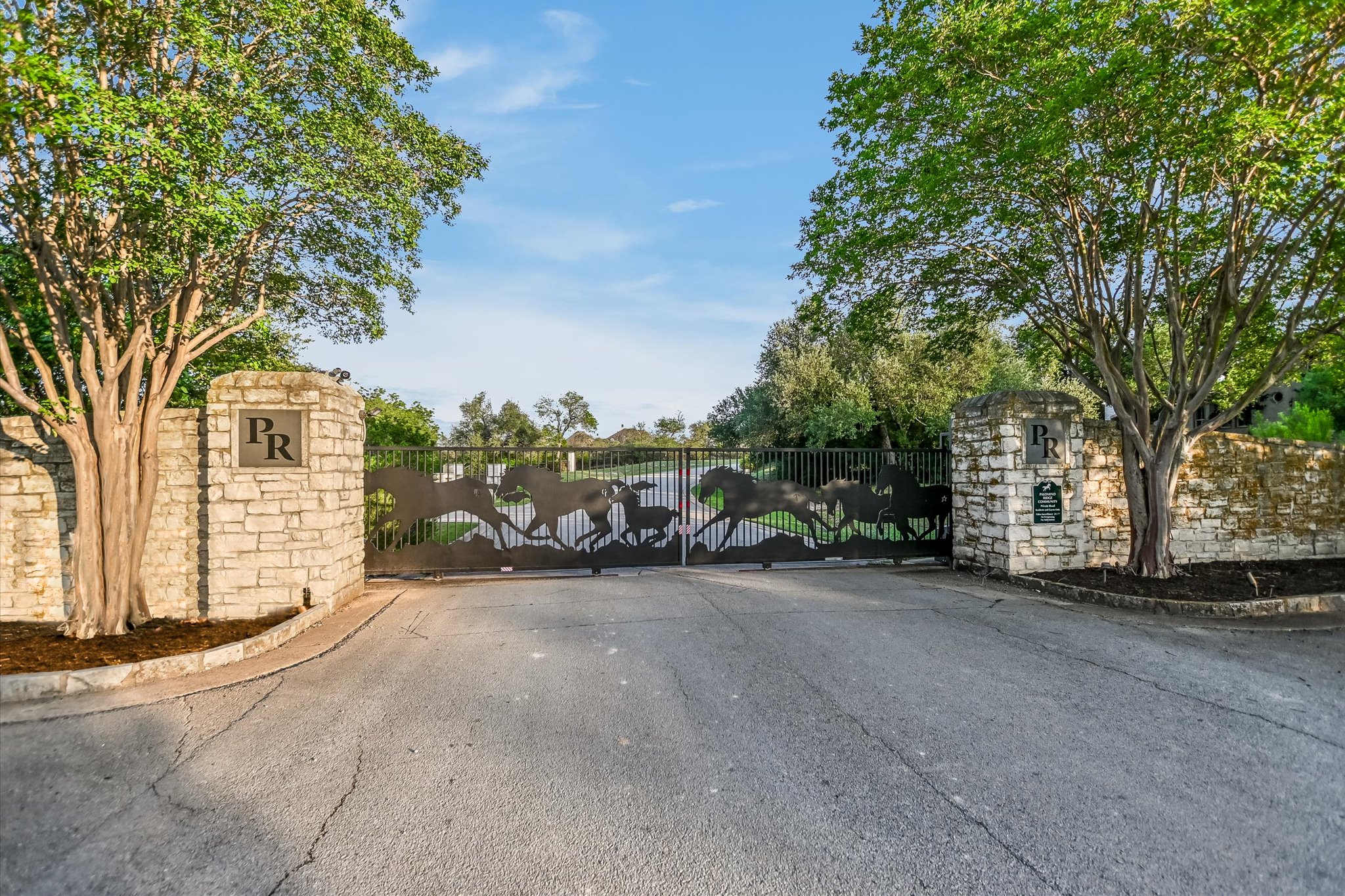 1422 Palomino Ridge Drive Austin, TX 78733 - Photo 60 of 60 a view of a car park next to a road and trees
