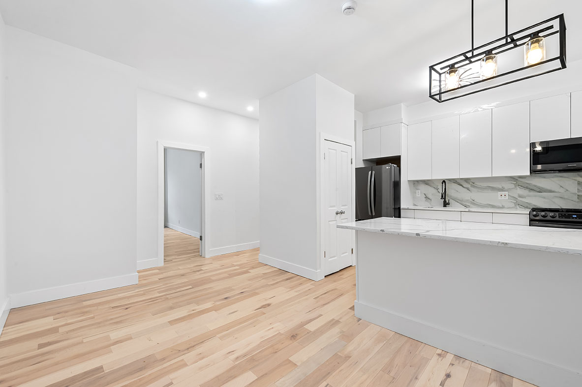 88 Brooklyn Avenue, Unit A3 Brooklyn, NY 11216 - Photo 8 of 12 a view of a kitchen with wooden floor and a sink