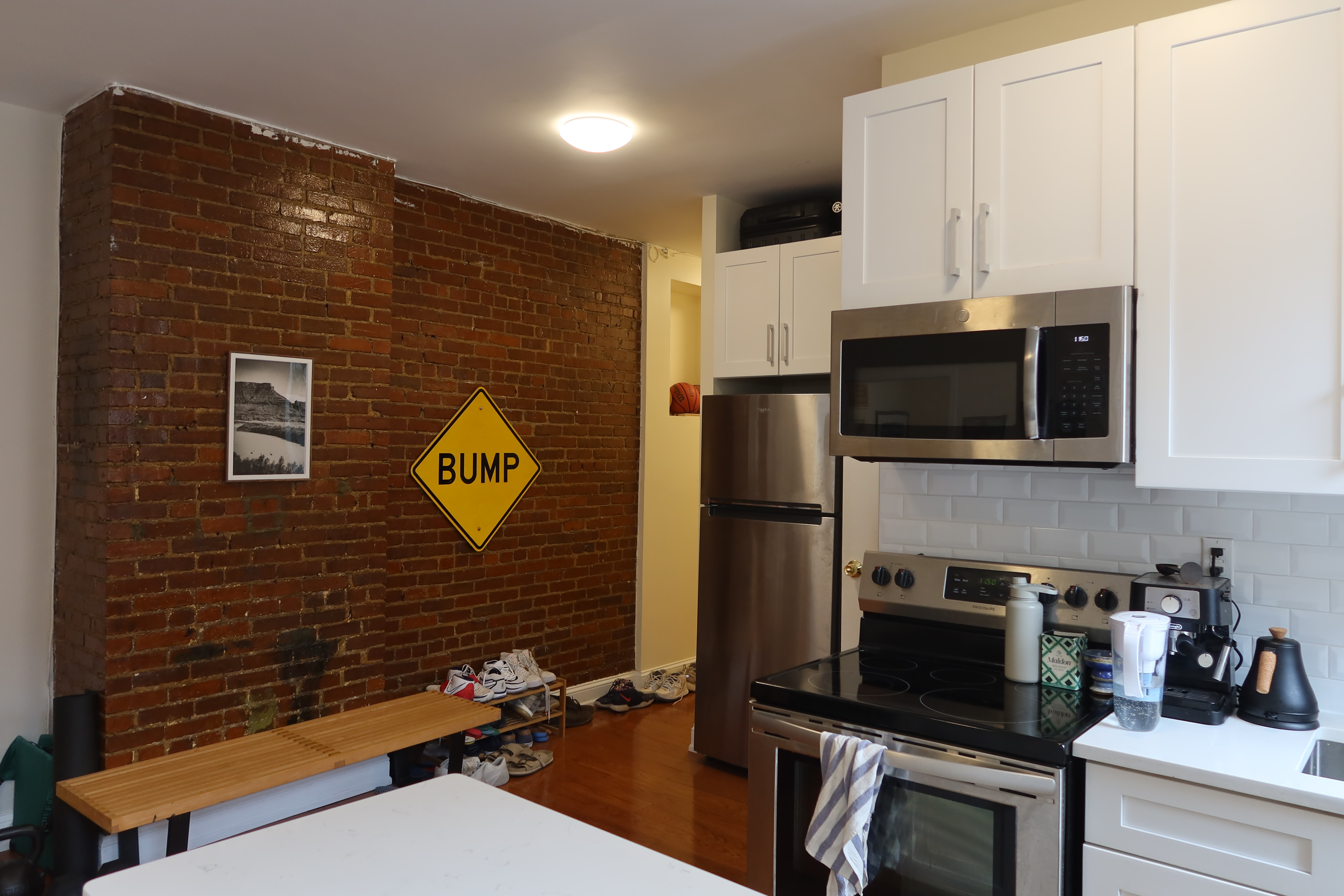 56 Stagg Street, Unit 4 Brooklyn, NY 11206 - Photo 7 of 11 a bathroom with a sink a stove and microwave