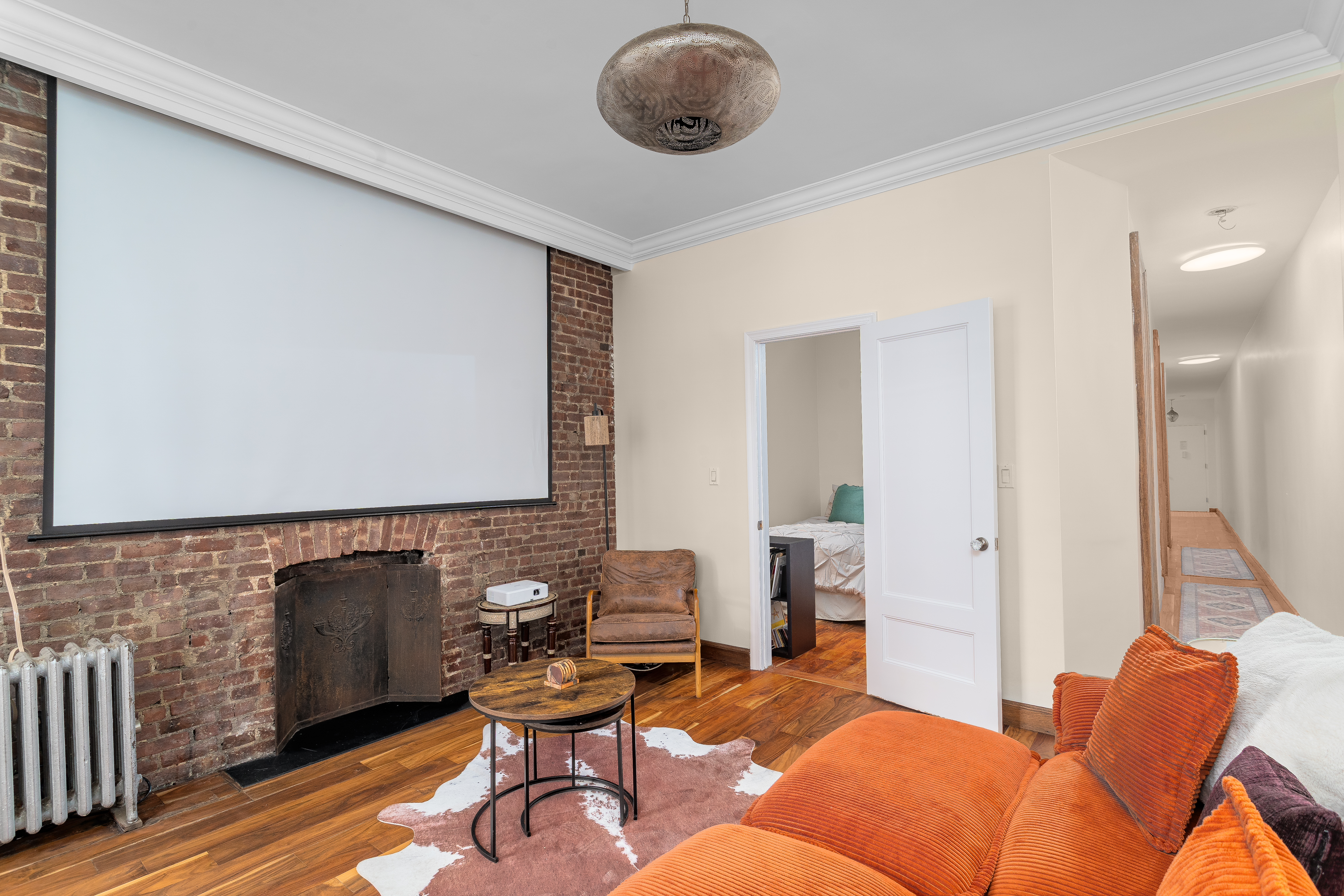 100 West 141st Street, Unit 33 Manhattan, NY 10030 - Photo 10 of 12 a living room with furniture and a wooden floor
