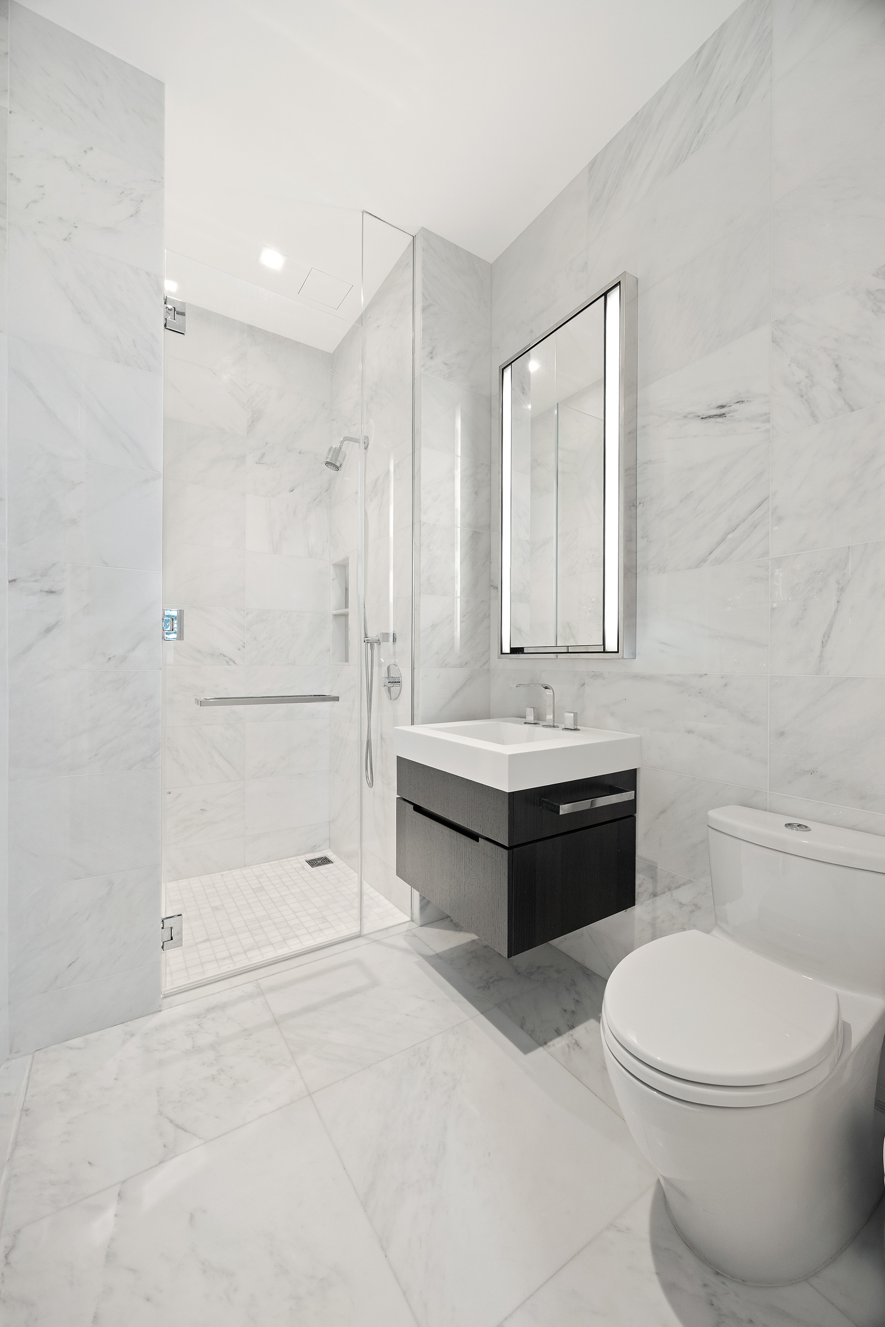 108 Leonard Street, Unit 5A Manhattan, NY 10013 - Photo 8 of 21 a bathroom with a bathtub shower sink mirror and toilet