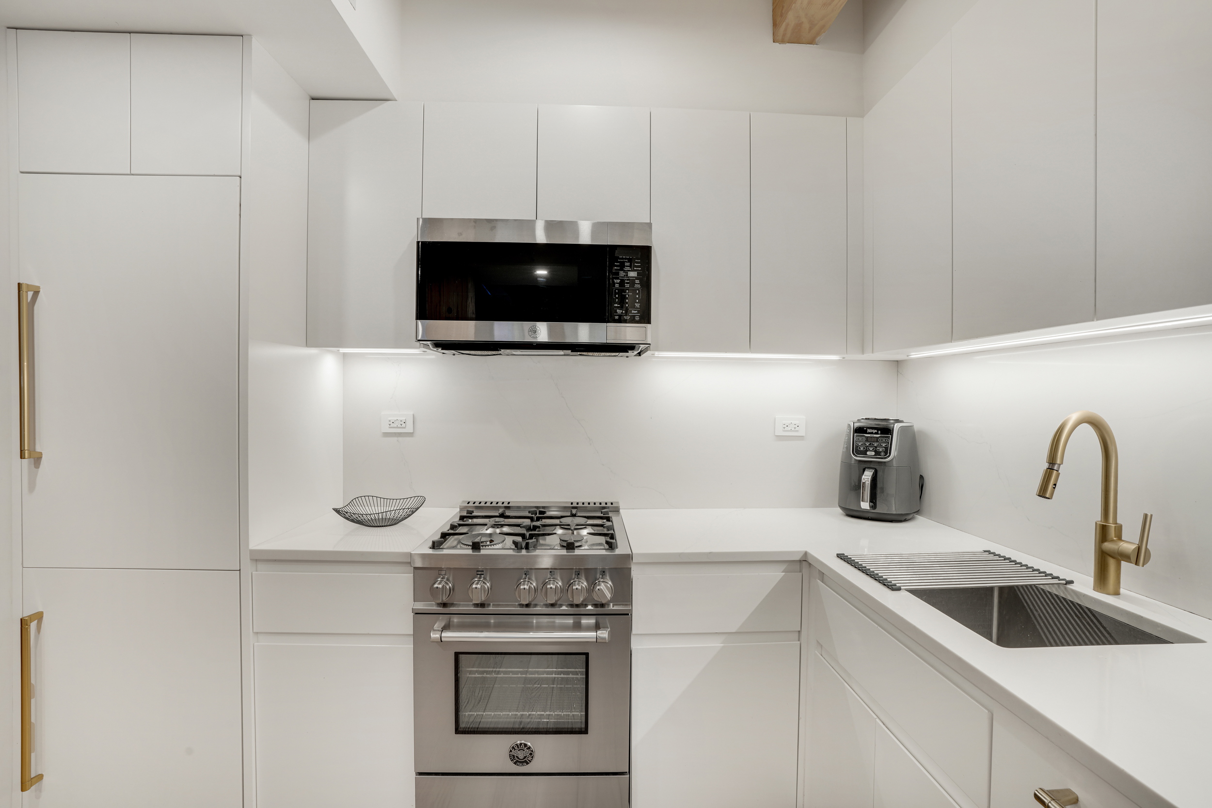 120 Java Street, Unit 1B Brooklyn, NY 11222 - Photo 2 of 12 a kitchen with a stove and a microwave