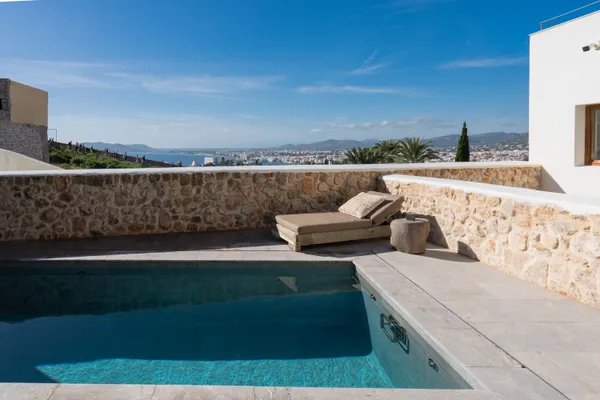 a view of a terrace with furniture and city view