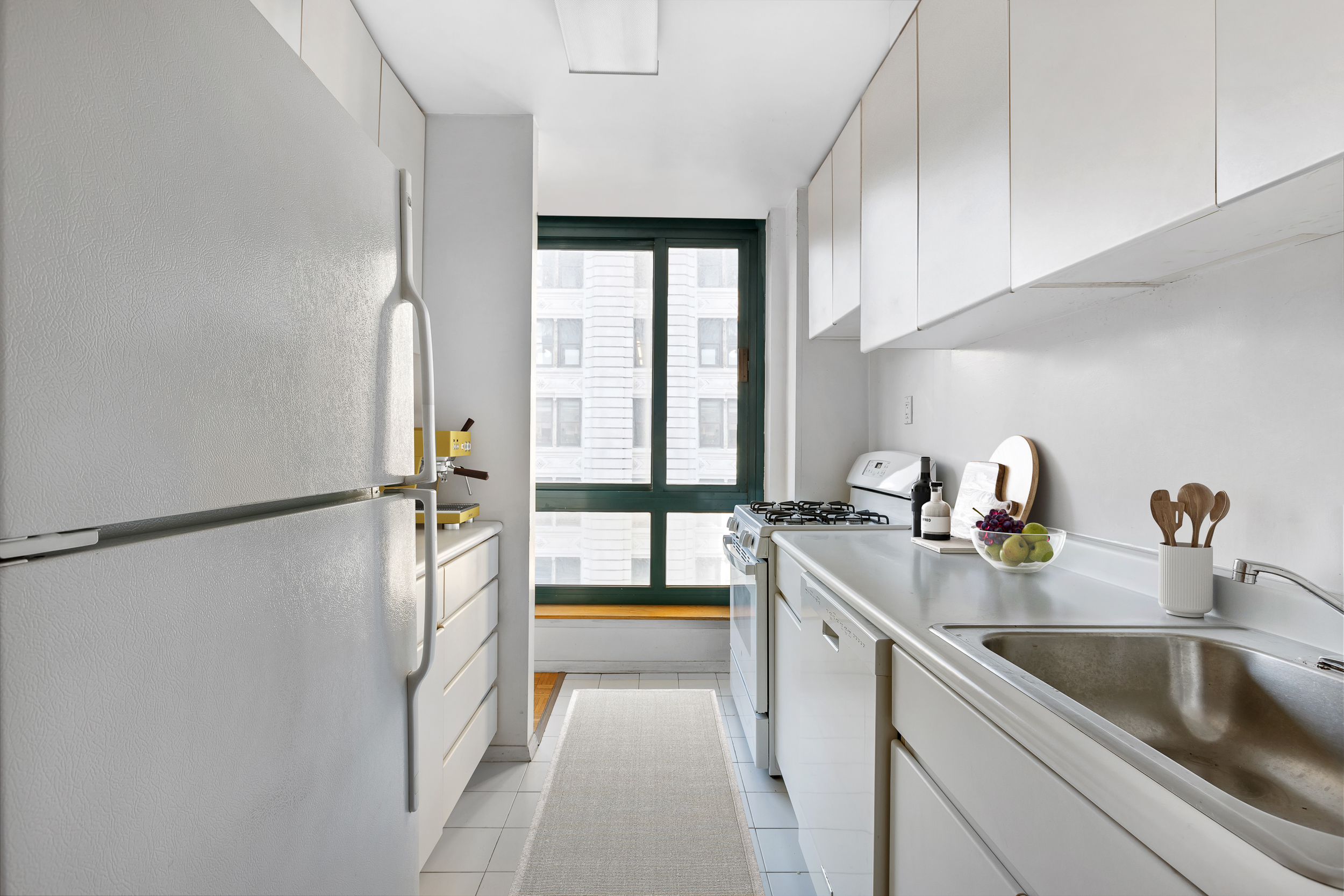 1 Irving Place, Unit G7G Manhattan, NY 10003 - Photo 4 of 8 a kitchen with a sink and a refrigerator