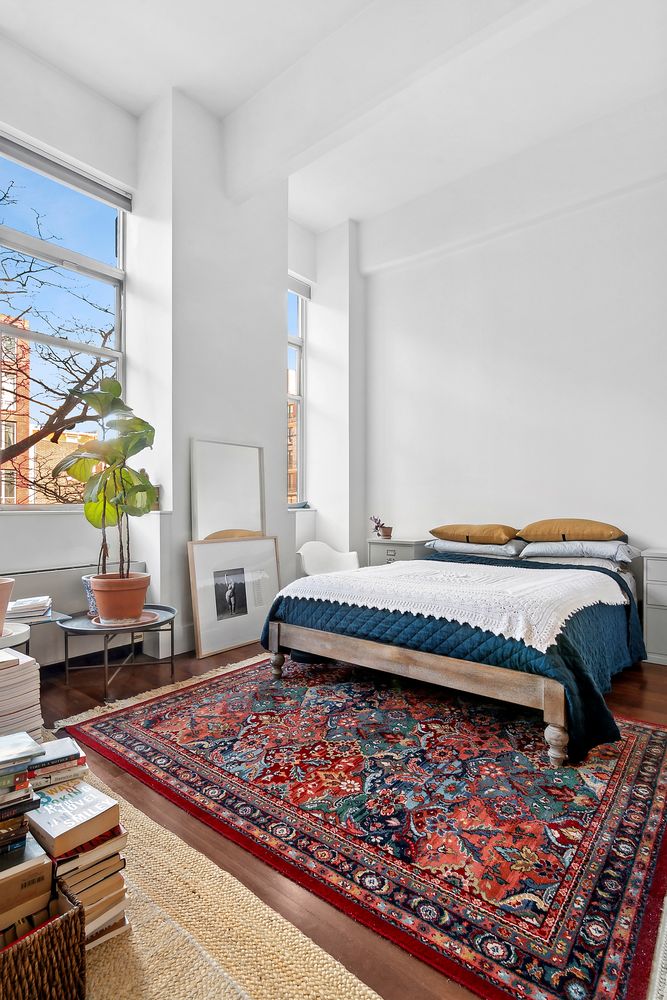 60 Broadway, Unit 2K Brooklyn, NY 11249 - Photo 3 of 7 a bed sitting in a bedroom next to a window