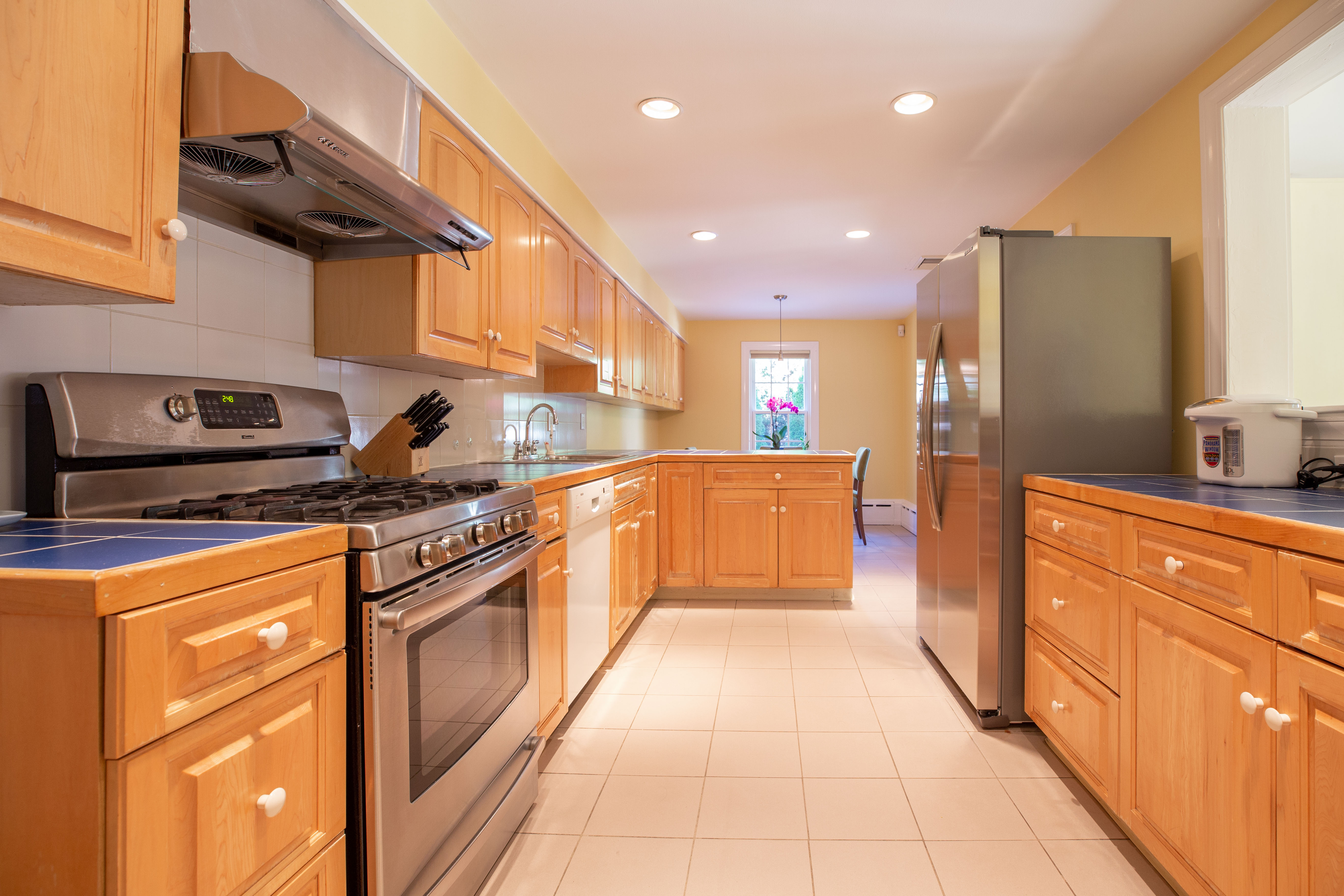 290 Dorset Road Waban, MA 02468 - Photo 7 of 23 a large kitchen with stainless steel appliances granite countertop a stove a sink and a refrigerator