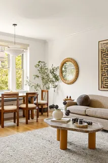 a living room with furniture a chandelier and a large window