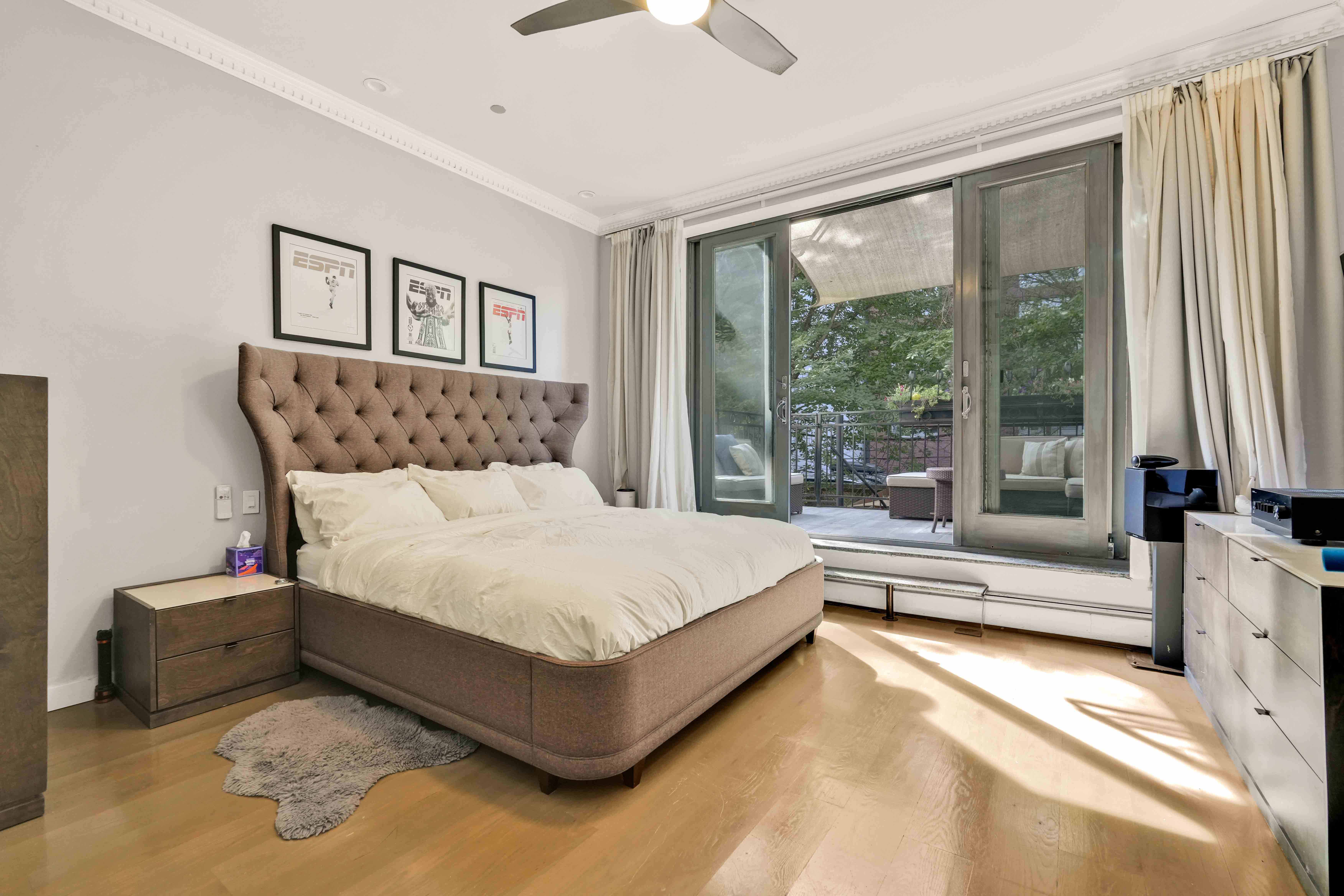 288 St James Place, Unit TRIPLEX Brooklyn, NY 11238 - Photo 14 of 25 a spacious bedroom with a bed and a large window with balcony view