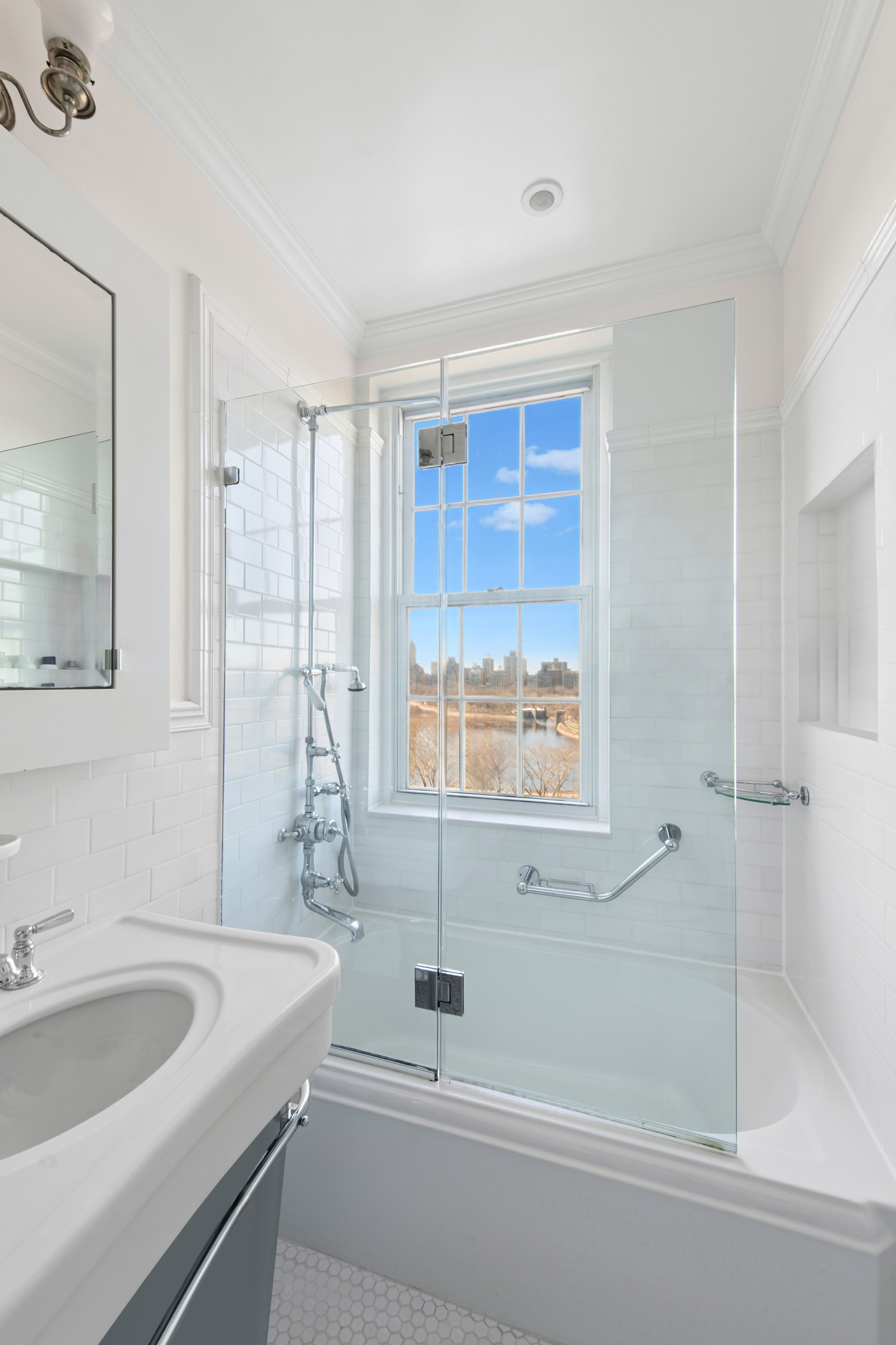 1140 5th Avenue, Unit 14B Manhattan, NY 10128 - Photo 12 of 18 a bathroom with a sink and a bathtub