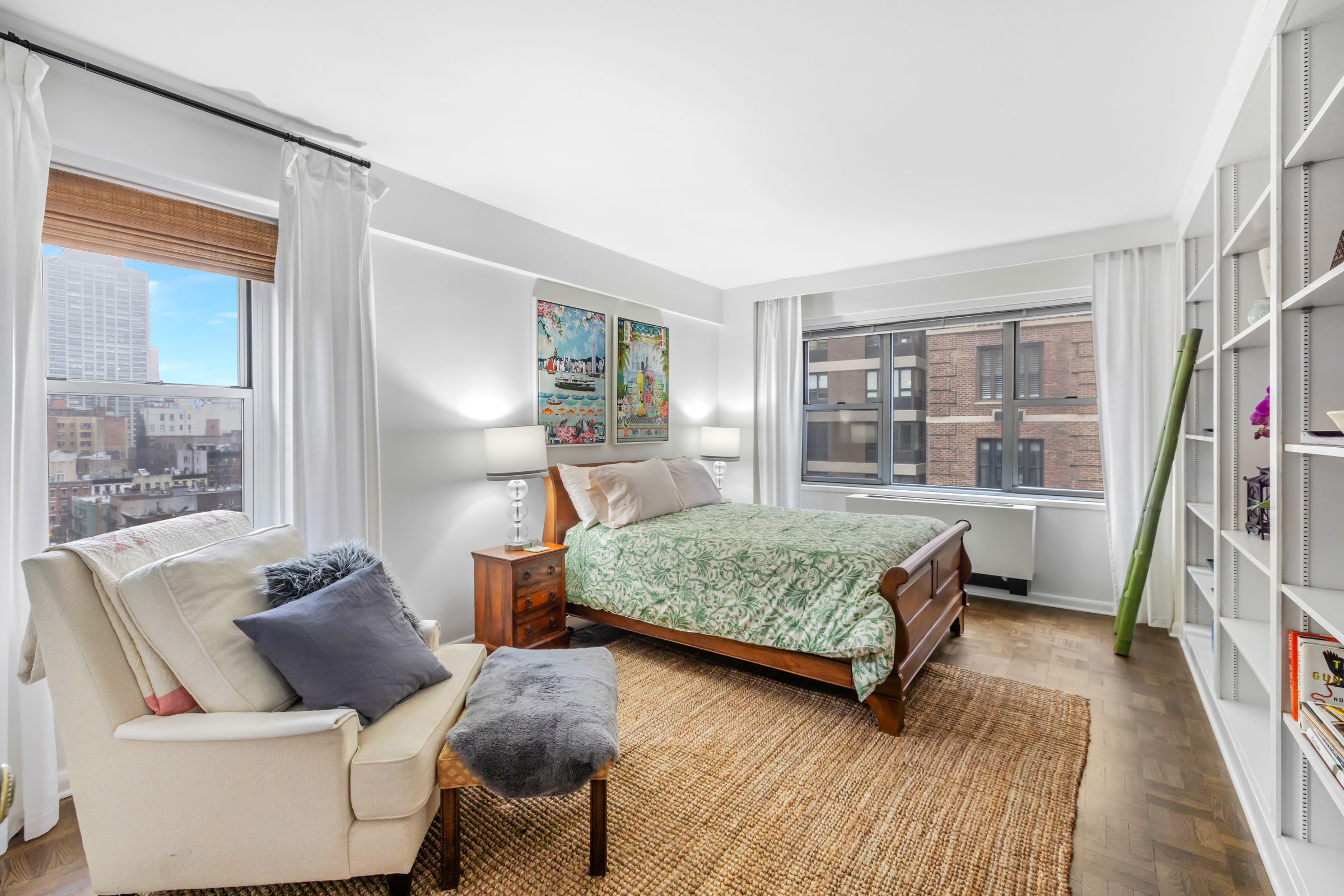 16 Sutton Place, Unit 11A Manhattan, NY 10022 - Photo 9 of 19 a bedroom with two beds and a large window