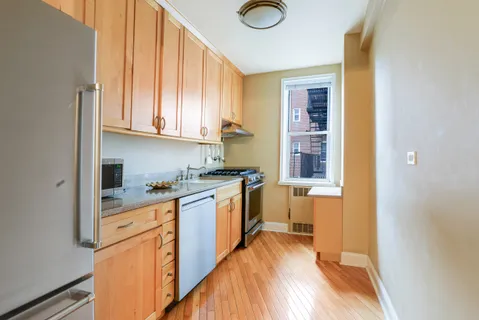 a kitchen with stainless steel appliances granite countertop a sink and cabinets