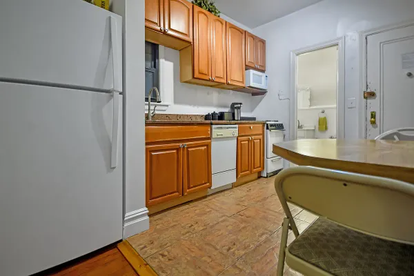 a kitchen with stainless steel appliances granite countertop a refrigerator and a sink