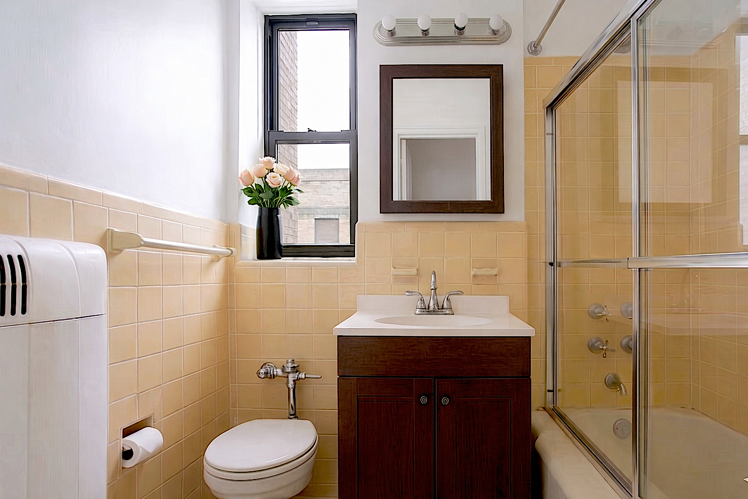 303 East 37th Street, Unit 3B Manhattan, NY 10016 - Photo 10 of 16 a bathroom with a toilet a sink and mirror