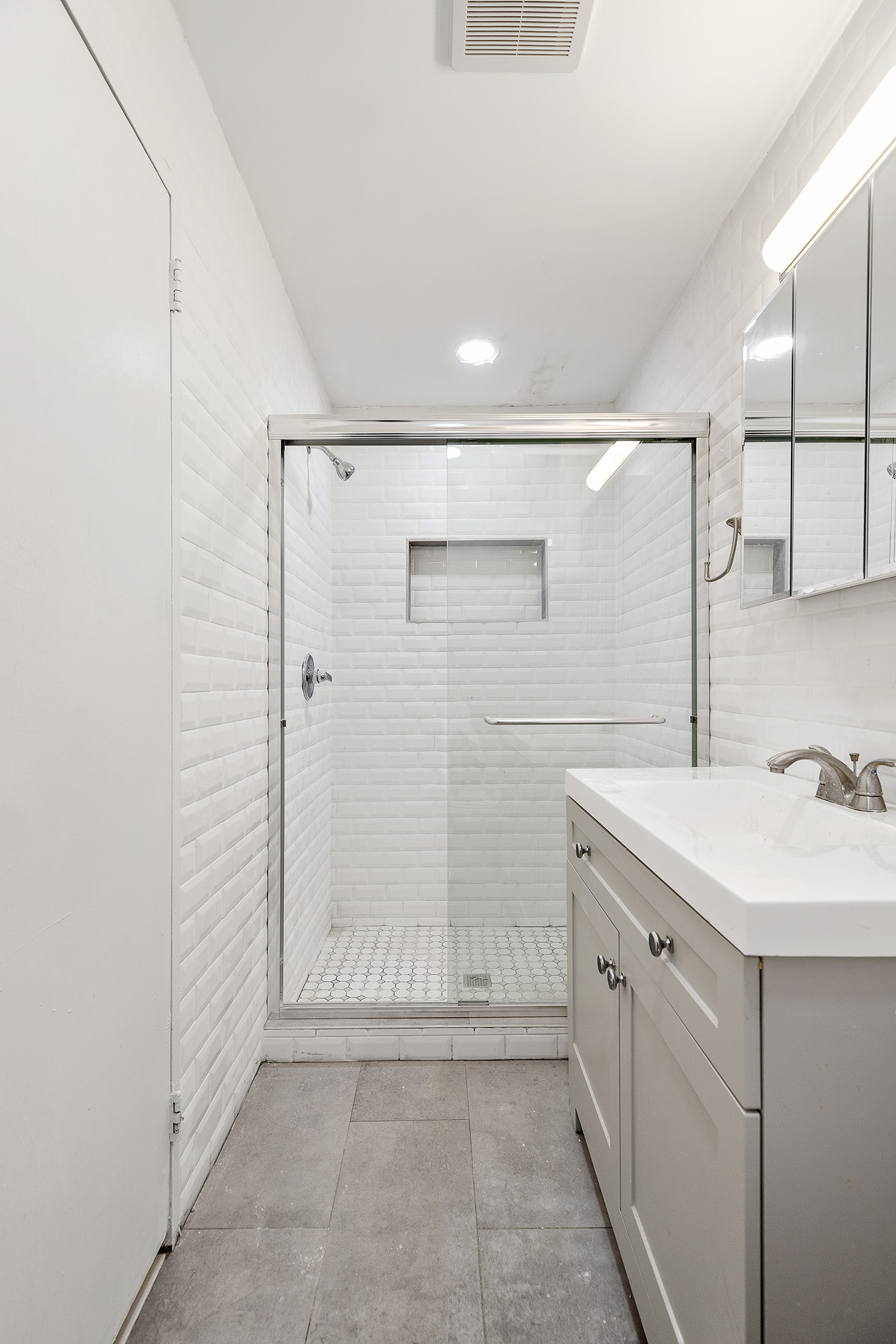 71 8th Avenue, Unit 3R Manhattan, NY 10014 - Photo 5 of 6 a bathroom with a shower sink and mirror