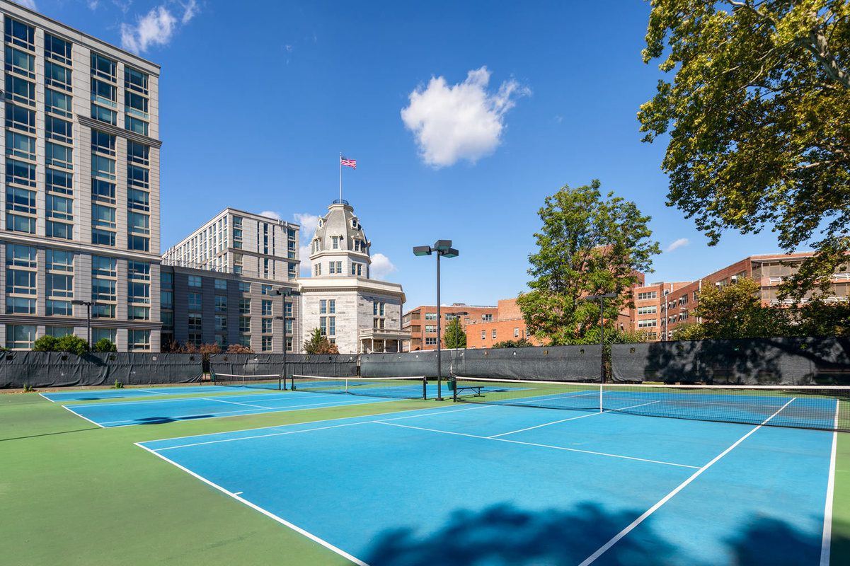 575 Main Street, Unit 509 Manhattan, NY 10044 - Photo 18 of 25 a view of a tennis ground with large trees