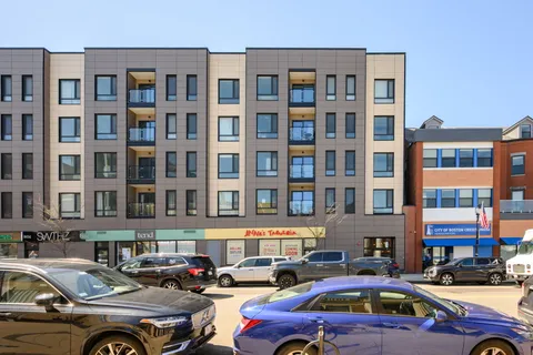 a cars parked in front of a brick building