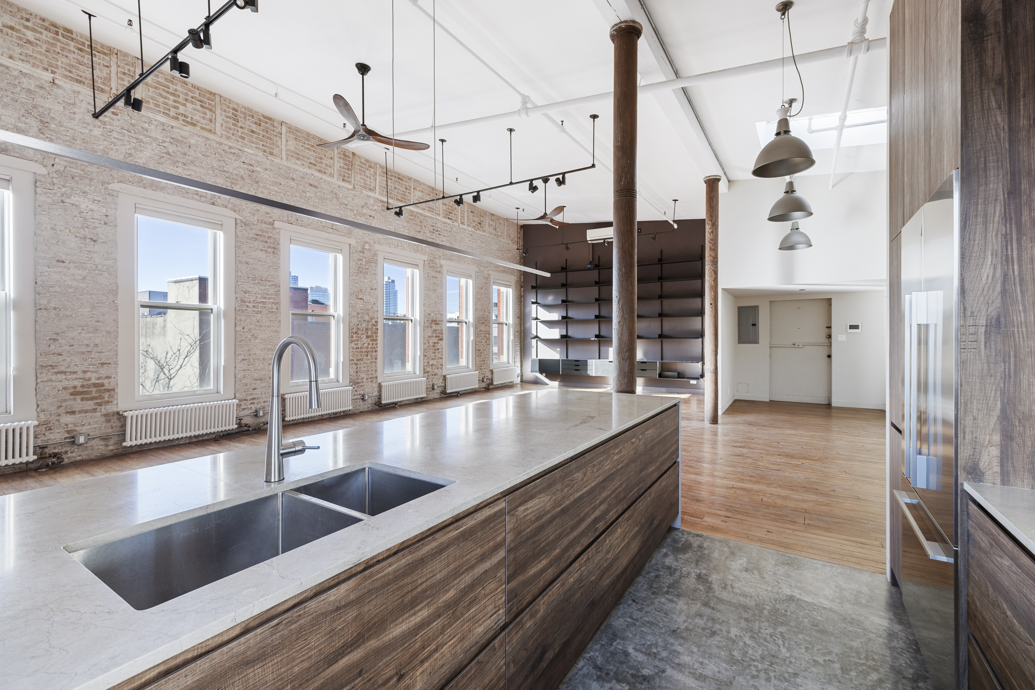 705 Driggs Avenue, Unit 13 Brooklyn, NY 11211 - Photo 7 of 15 a view of a kitchen with a sink and wooden floor