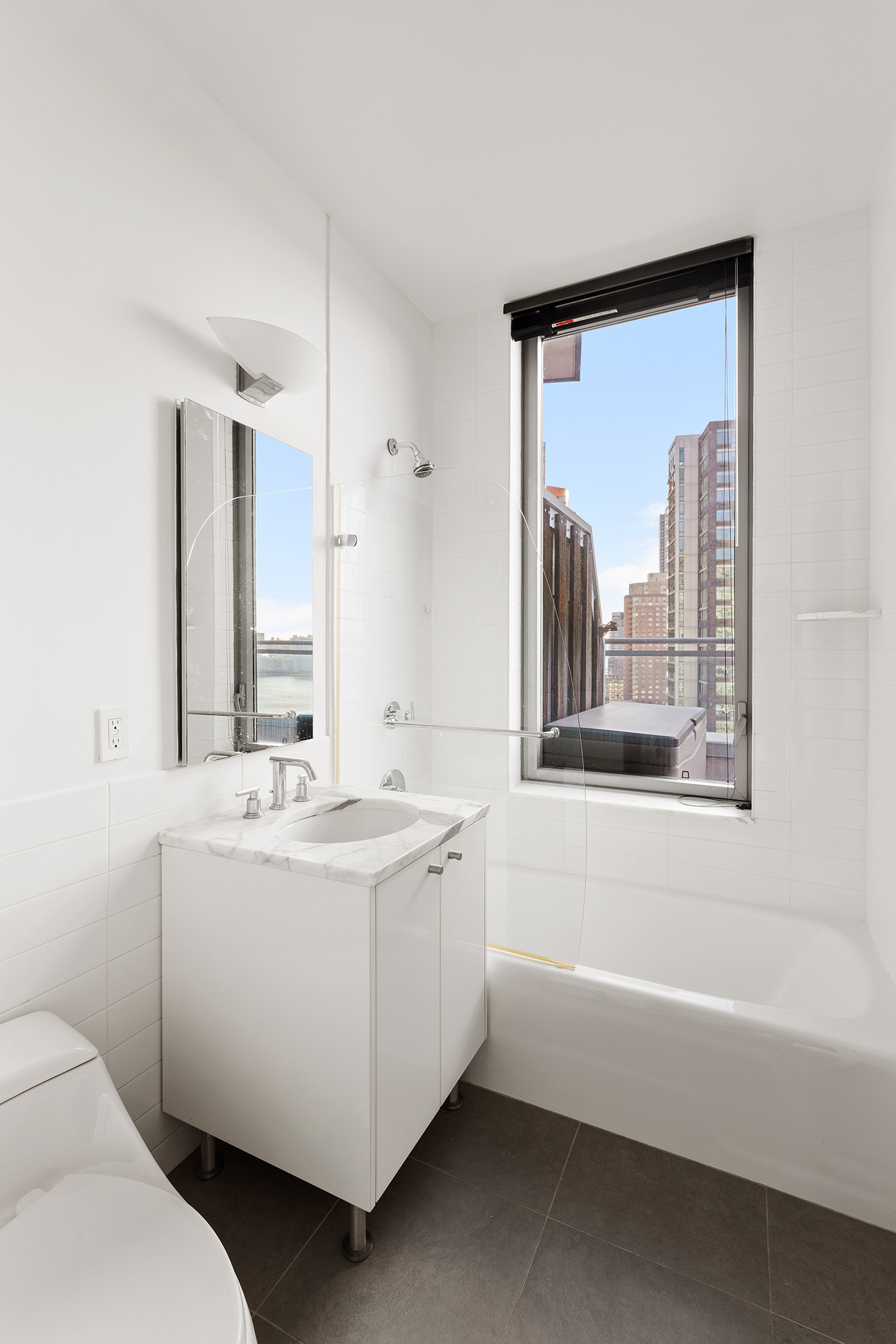 46-30 Center Boulevard, Unit PH8 Queens, NY 11109 - Photo 19 of 32 a bathroom with a sink a toilet and a bathtub