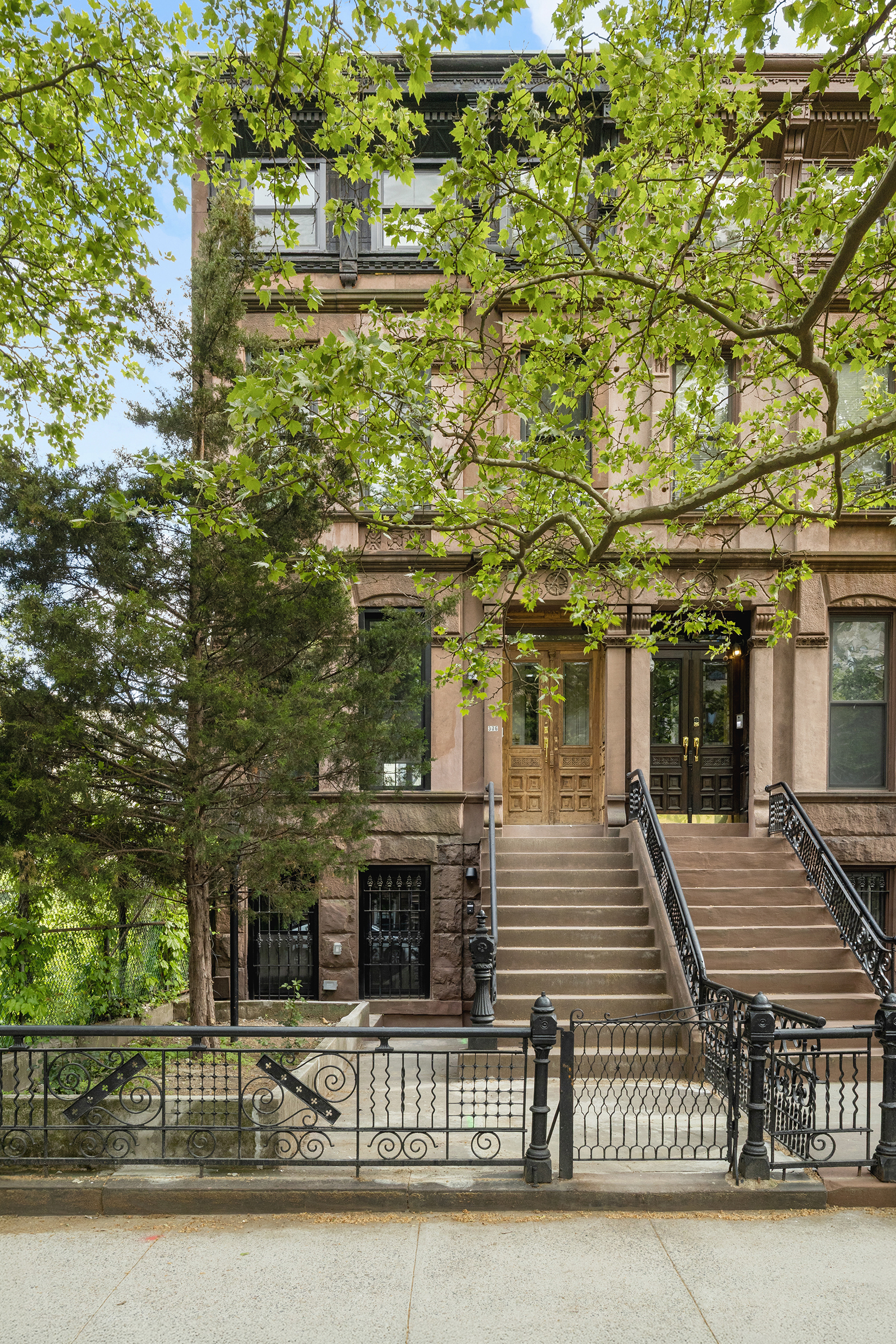 306 Halsey Street Brooklyn, NY 11216 - Photo 9 of 10 a view of a brick house with many windows