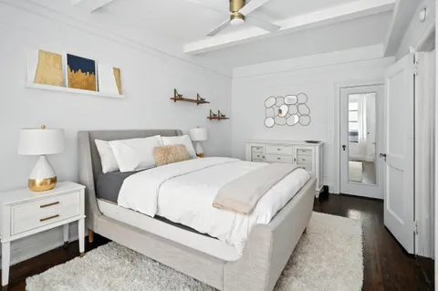 a bedroom with a bed and a night stand