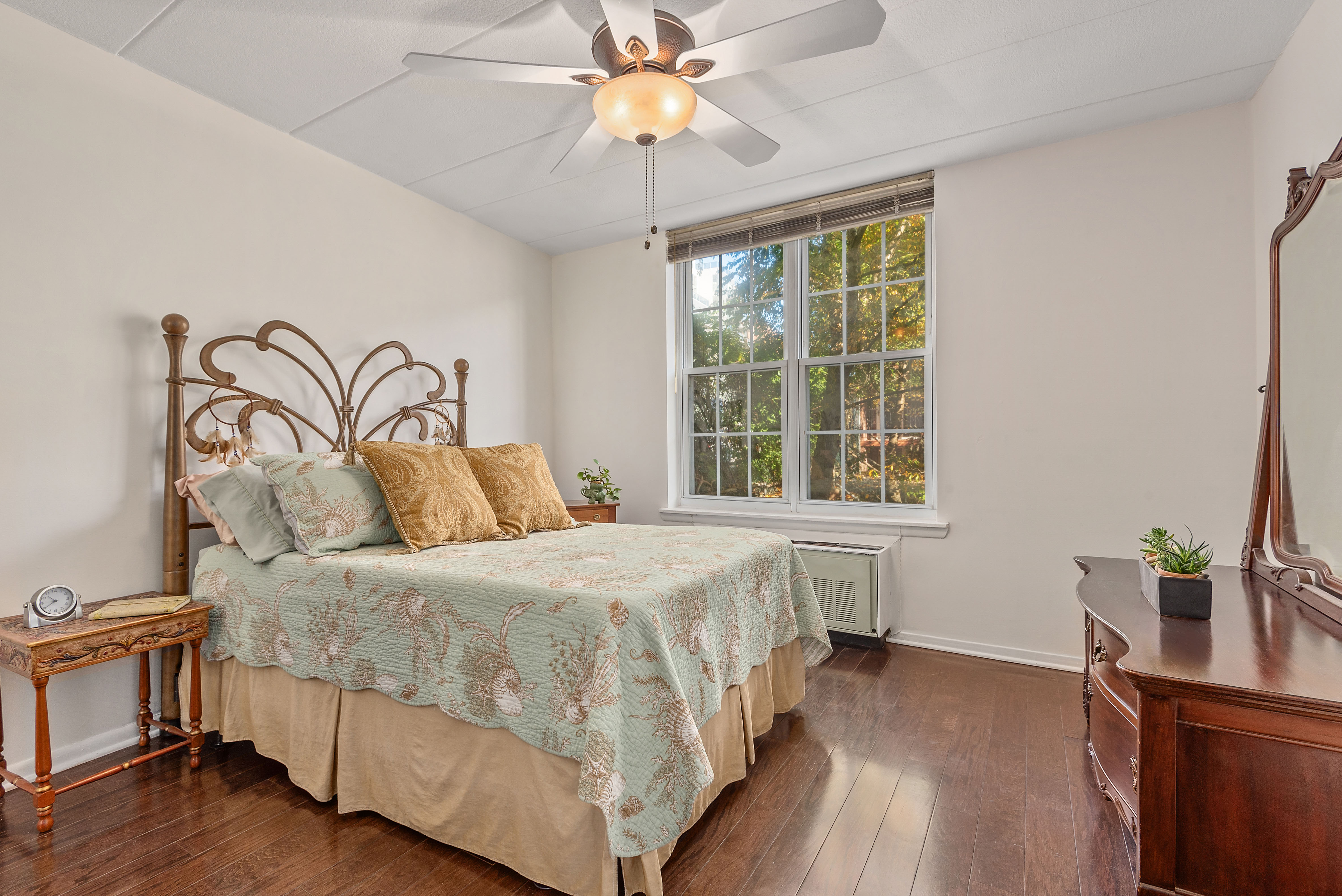 9951 Shore Road, Unit 1B Brooklyn, NY 11209 - Photo 6 of 9 a bedroom with a bed and a chandelier