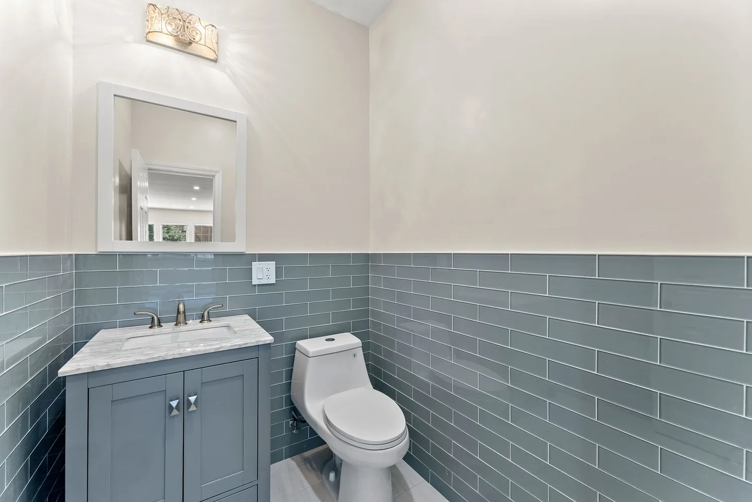 a bathroom with a sink a toilet and mirror