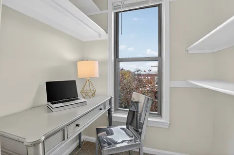 a living room with a flat screen tv and a window