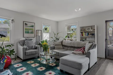 a living room with furniture and painting on the wall