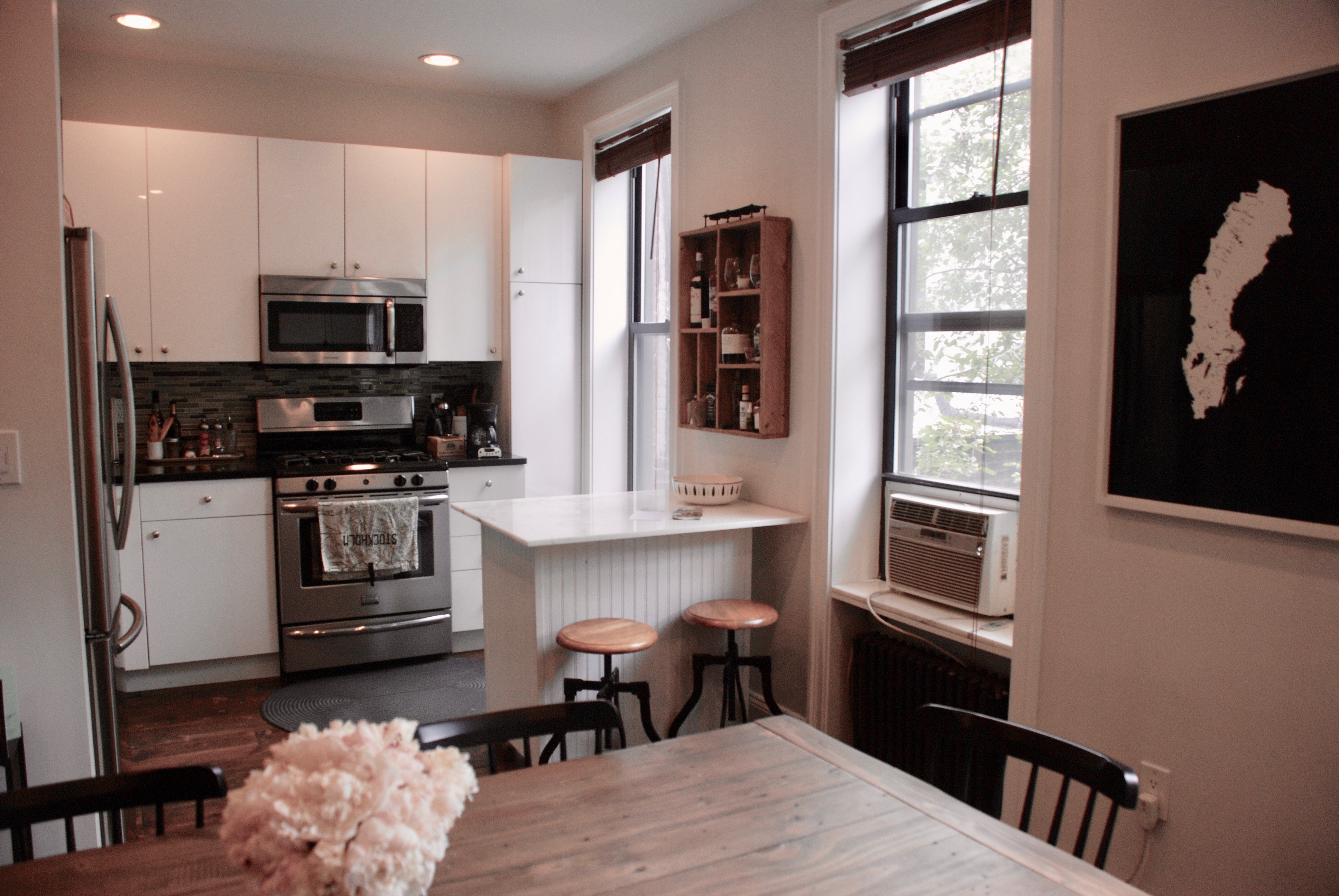 511 Clinton Street, Unit 2 Brooklyn, NY 11231 - Photo 1 of 12 a kitchen with stainless steel appliances kitchen island granite countertop a stove a sink and a microwave
