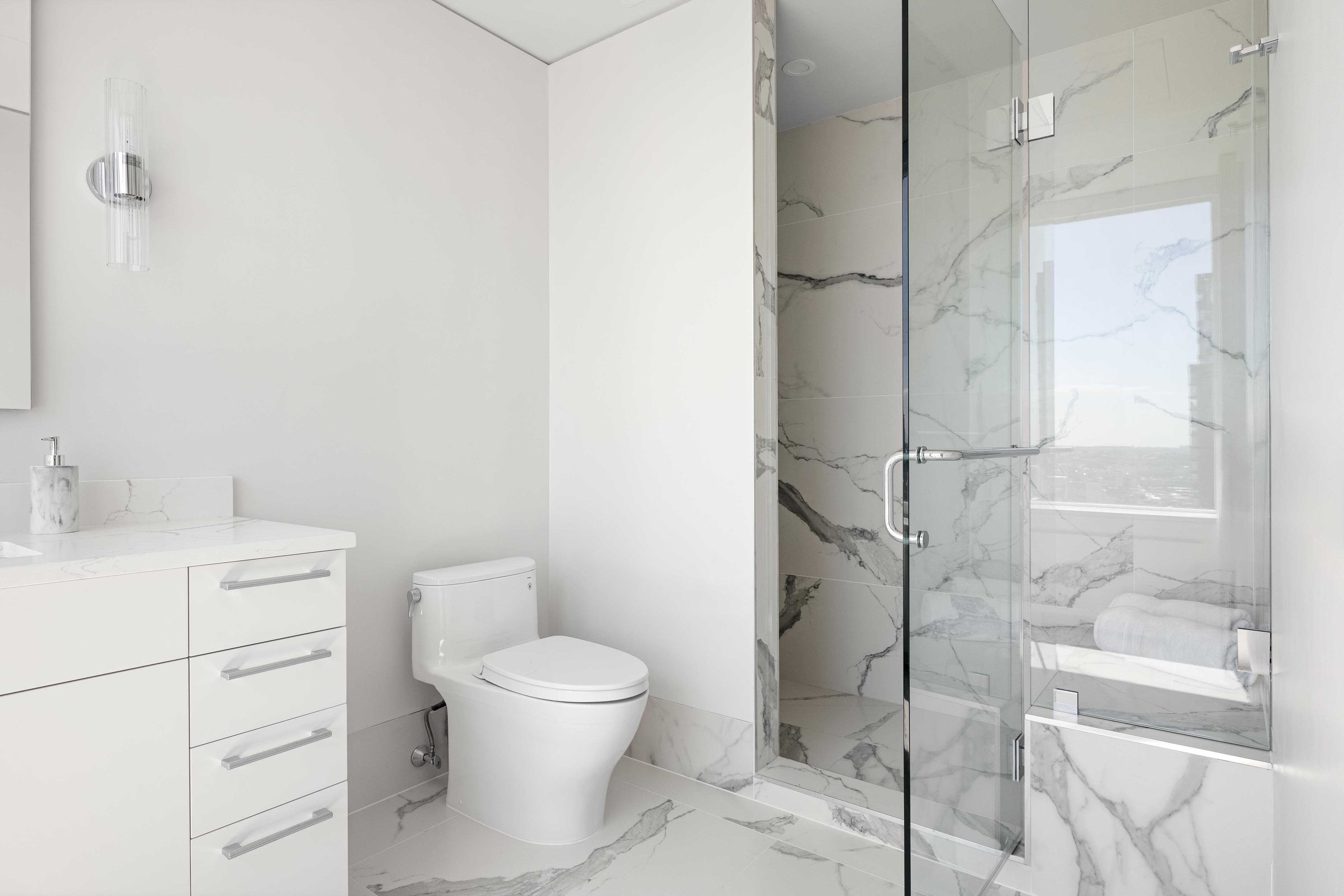 422 East 72nd Street, Unit 37AD Manhattan, NY 10021 - Photo 19 of 38 a white toilet sitting next to a bathroom sink